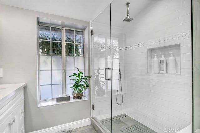 bathroom featuring vanity and a shower with shower door