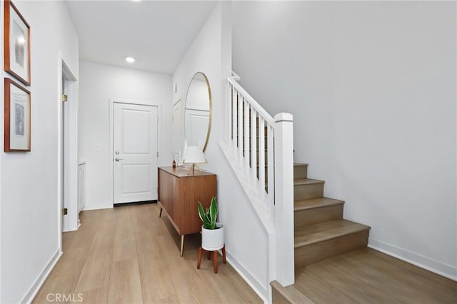 stairway with hardwood / wood-style floors