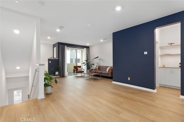 interior space with built in features and light hardwood / wood-style floors