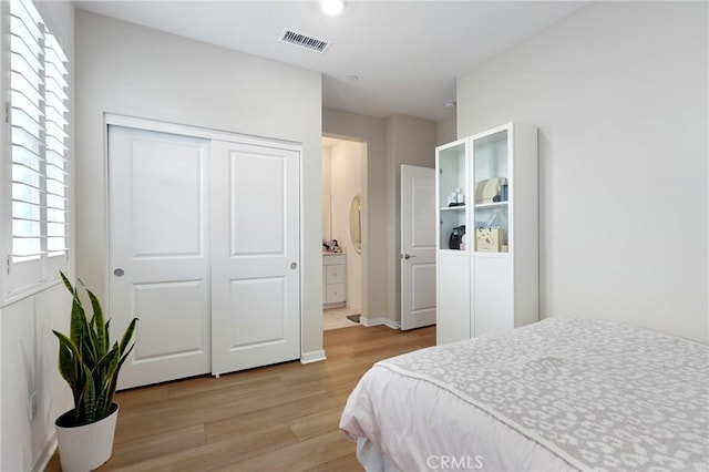 bedroom with a closet and light wood-type flooring