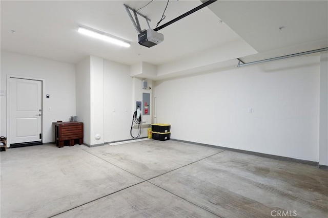 garage with a garage door opener and electric panel