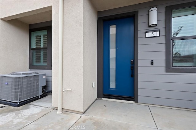 property entrance featuring central AC unit