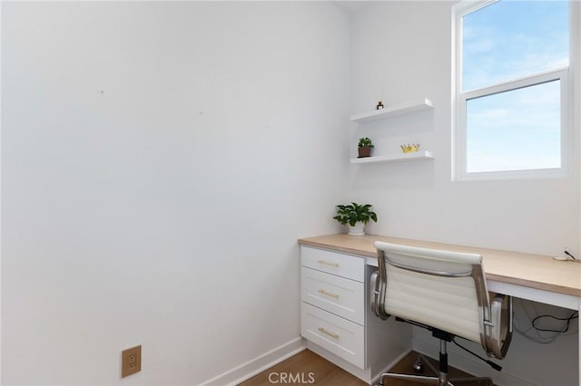 office area featuring hardwood / wood-style flooring and built in desk