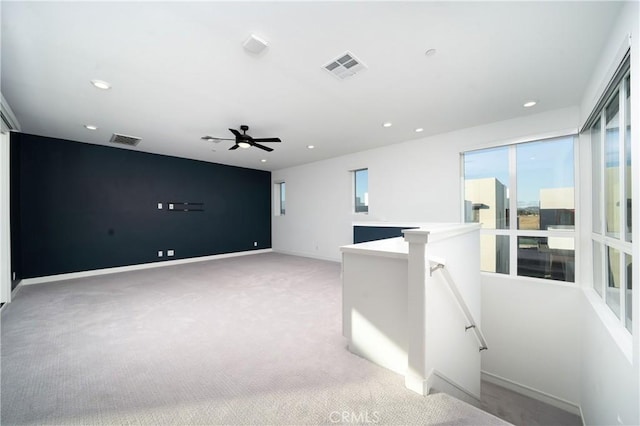 carpeted spare room with ceiling fan