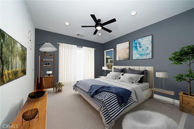 bedroom featuring light colored carpet and ceiling fan