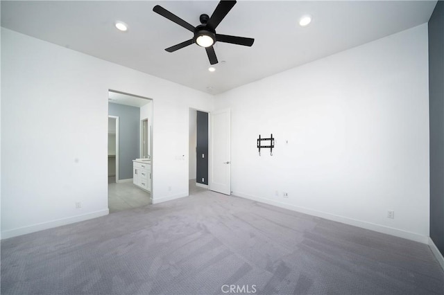 unfurnished bedroom with light colored carpet and ensuite bath