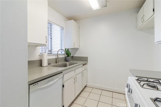 kitchen with light tile patterned flooring, white appliances, sink, and white cabinets