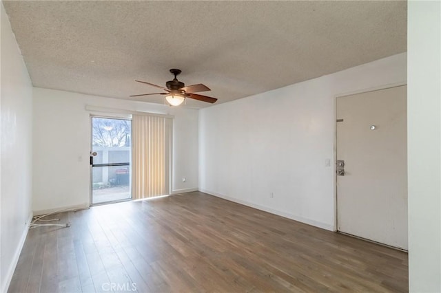 empty room featuring ceiling fan, hardwood / wood-style floors, and a textured ceiling