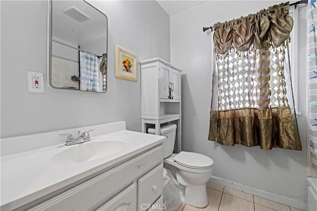 bathroom with vanity, toilet, curtained shower, and tile patterned flooring