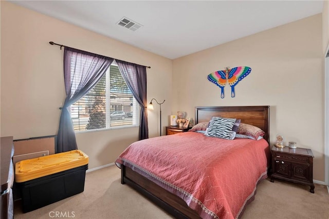 bedroom with carpet, visible vents, and baseboards