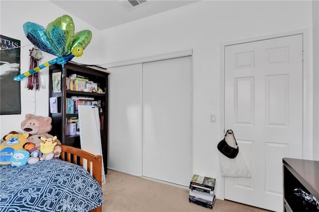 bedroom with a closet, carpet, and visible vents