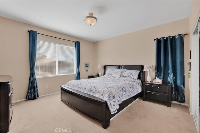 bedroom featuring baseboards and light colored carpet