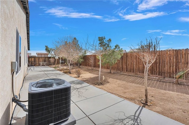 view of patio / terrace with central AC and a fenced backyard