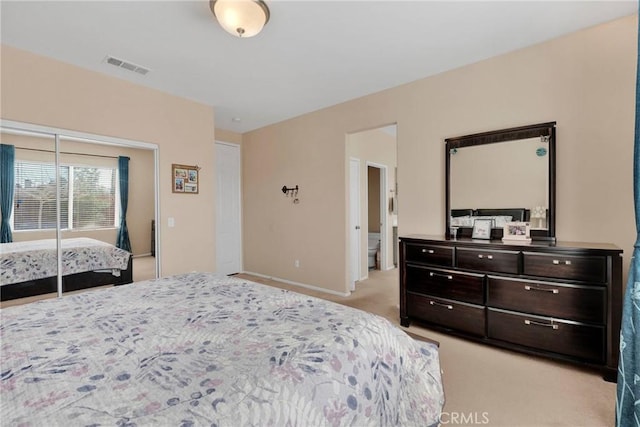 bedroom with baseboards, visible vents, and light colored carpet