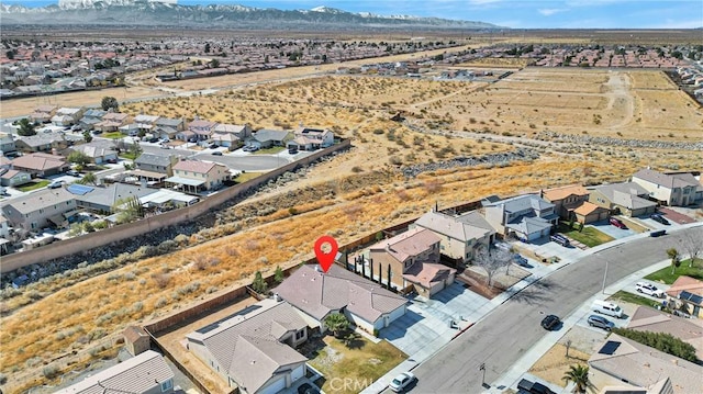 birds eye view of property with view of desert, a residential view, and a mountain view