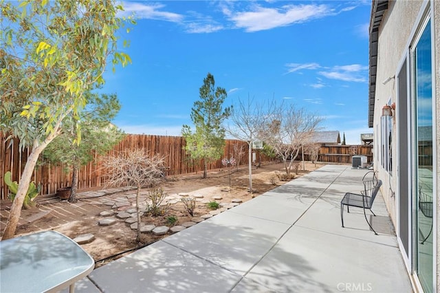 view of patio with a fenced backyard and cooling unit