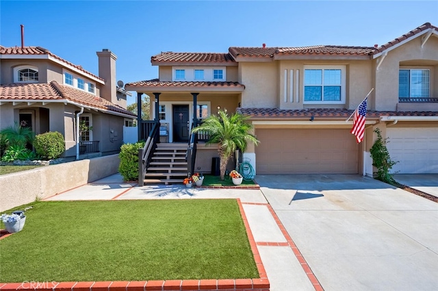 mediterranean / spanish-style home with a front yard and a garage