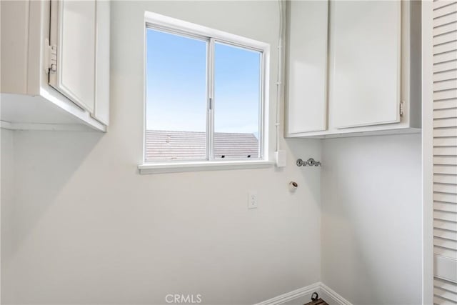 laundry area with cabinets