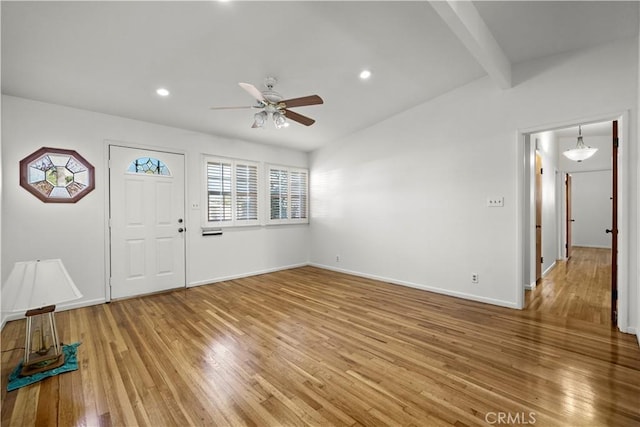 foyer entrance featuring lofted ceiling with beams, ceiling fan, and hardwood / wood-style floors