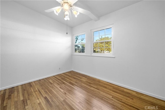 empty room with vaulted ceiling with beams, wood-type flooring, and ceiling fan