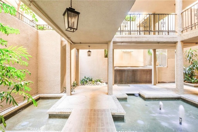 view of patio featuring a balcony