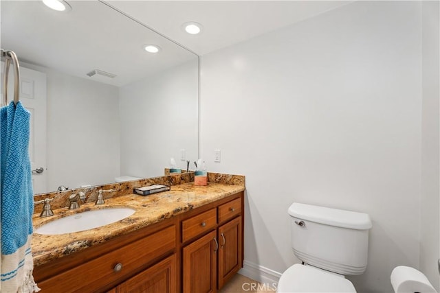 bathroom featuring vanity and toilet