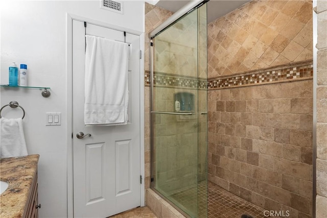 bathroom featuring walk in shower and vanity