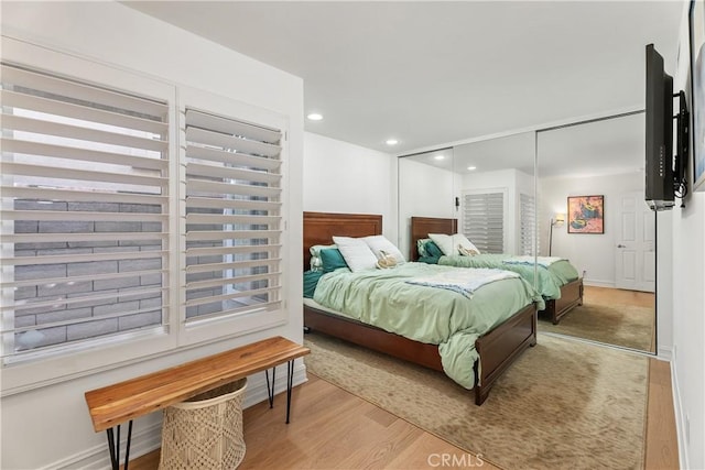 bedroom featuring light wood-type flooring and a closet