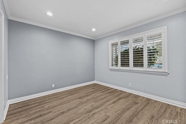 unfurnished room featuring hardwood / wood-style flooring and ornamental molding