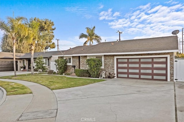 single story home with a garage and a front yard