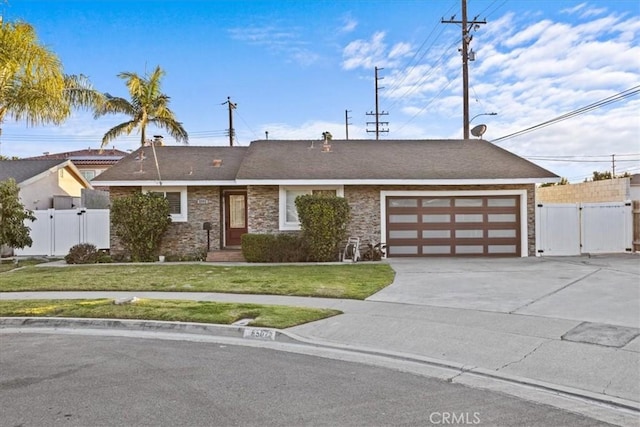 ranch-style home featuring a garage and a front yard