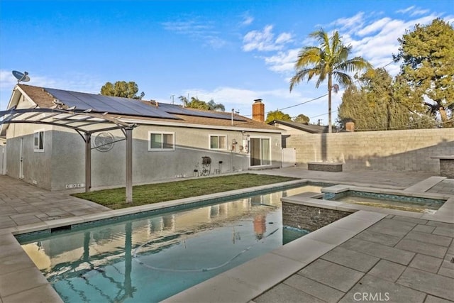 view of swimming pool featuring an in ground hot tub