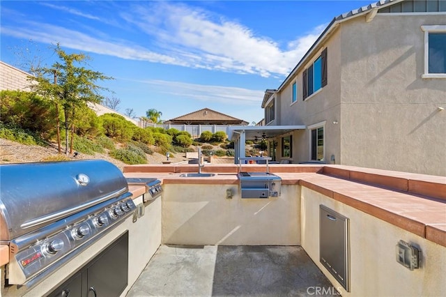 view of patio featuring a grill and an outdoor kitchen