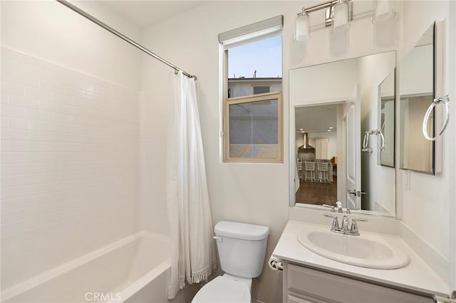 full bathroom with vanity, shower / bath combination with curtain, and toilet