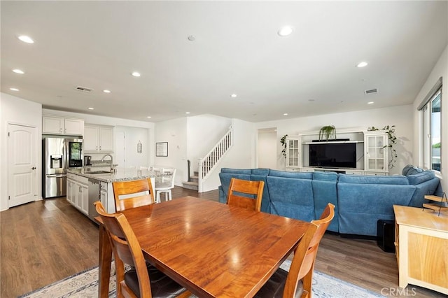 dining space featuring dark hardwood / wood-style floors and sink