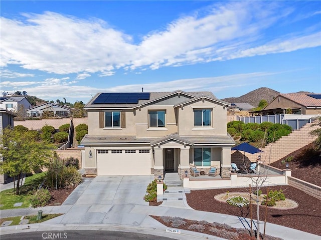 view of front of property with a garage and solar panels