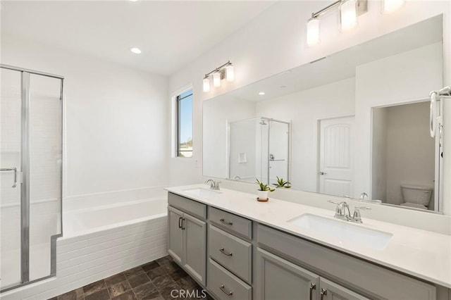 full bathroom with vanity, toilet, and separate shower and tub