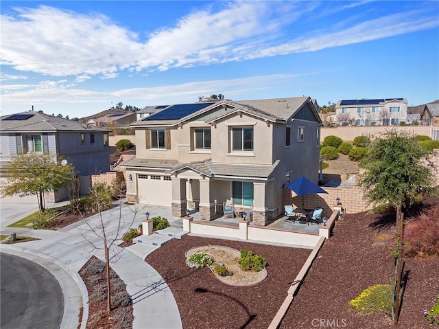 view of front of property featuring a garage and solar panels