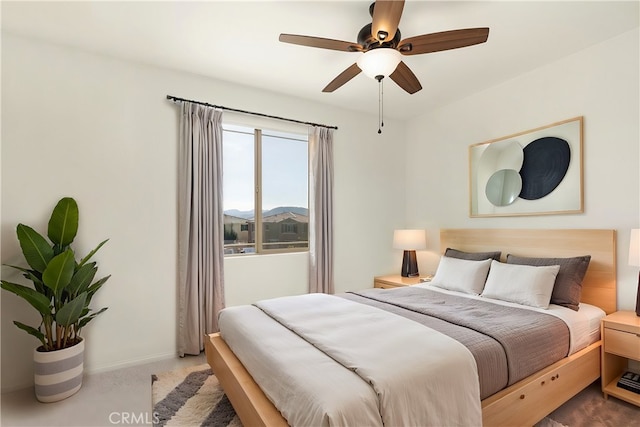 bedroom featuring ceiling fan and carpet