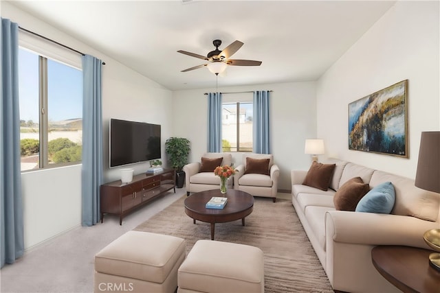 living room featuring light carpet and ceiling fan