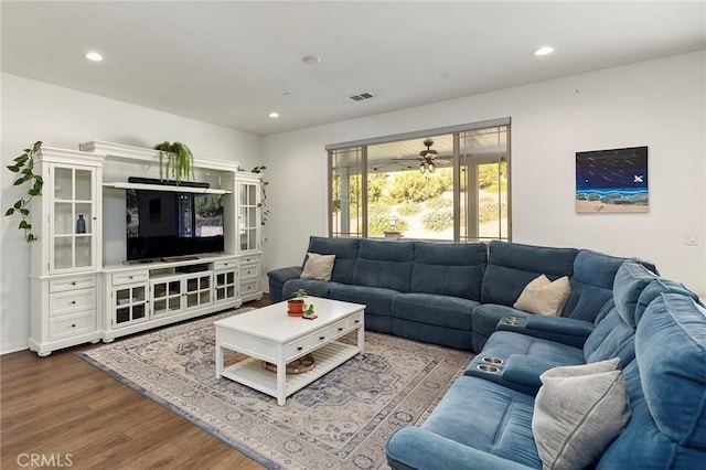 living room featuring hardwood / wood-style floors and ceiling fan