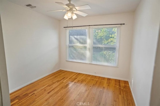 spare room with ceiling fan and light wood-type flooring