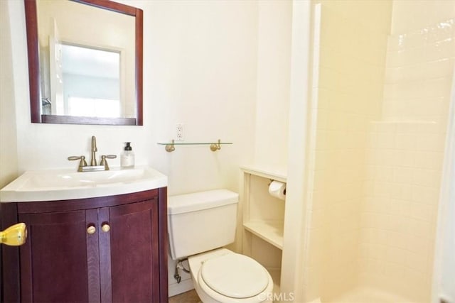 bathroom with vanity, walk in shower, and toilet