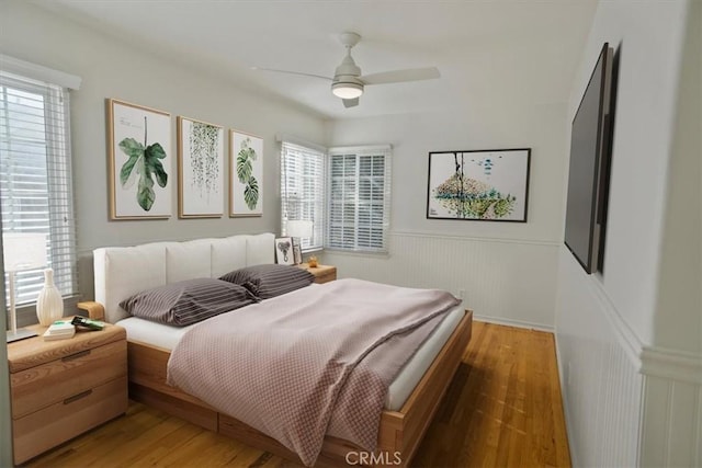 bedroom with dark wood-type flooring and ceiling fan