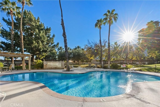 community pool featuring a patio area and fence