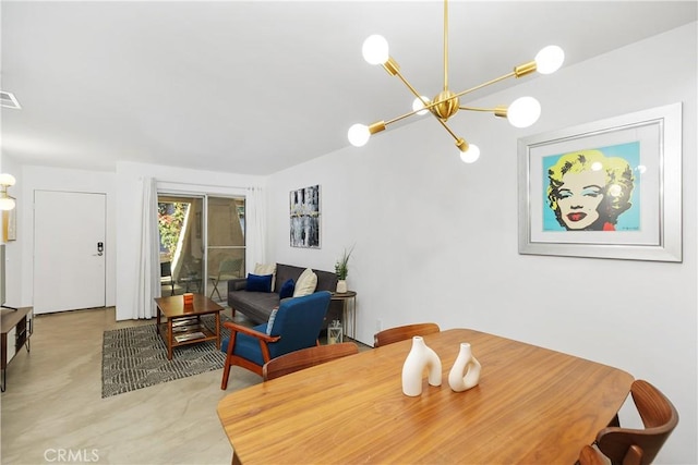 dining area featuring a notable chandelier and finished concrete floors