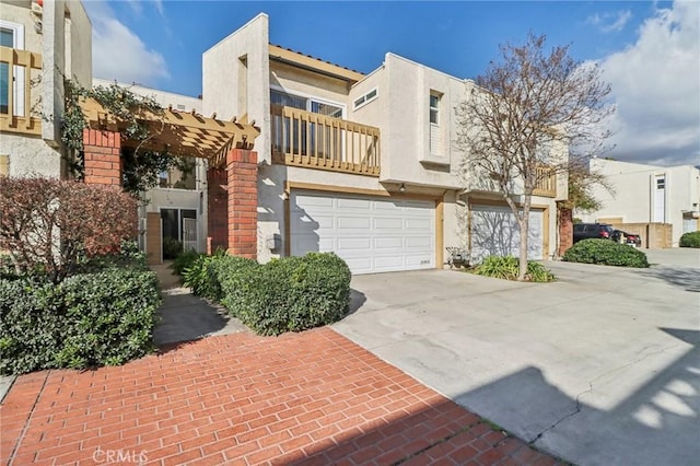 view of front of home featuring a balcony, a garage, and a pergola