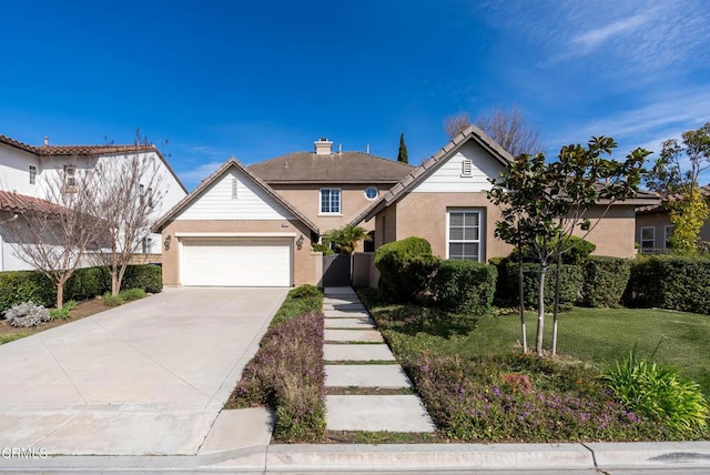 view of front of home featuring a garage and a front yard