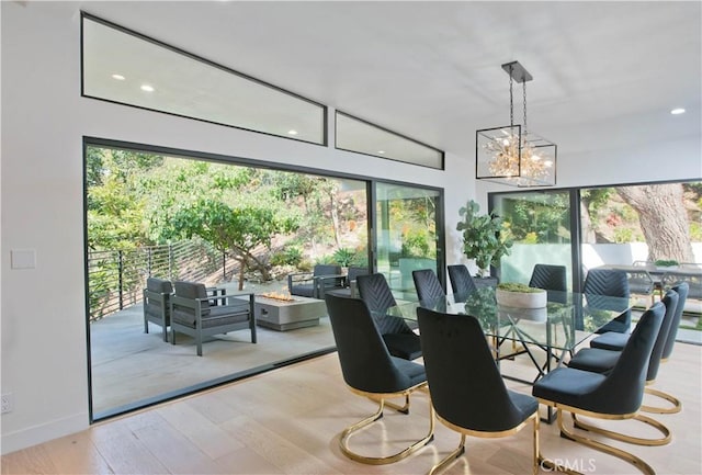 interior space featuring an inviting chandelier, a healthy amount of sunlight, and light wood-type flooring