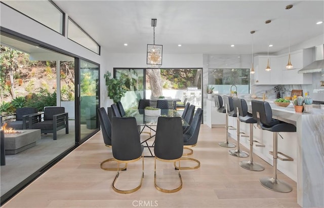 dining area with light hardwood / wood-style floors and a wealth of natural light